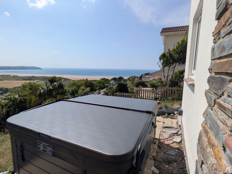 A hot tub with a view of the sea and landscape at Belvedere in Woolacombe