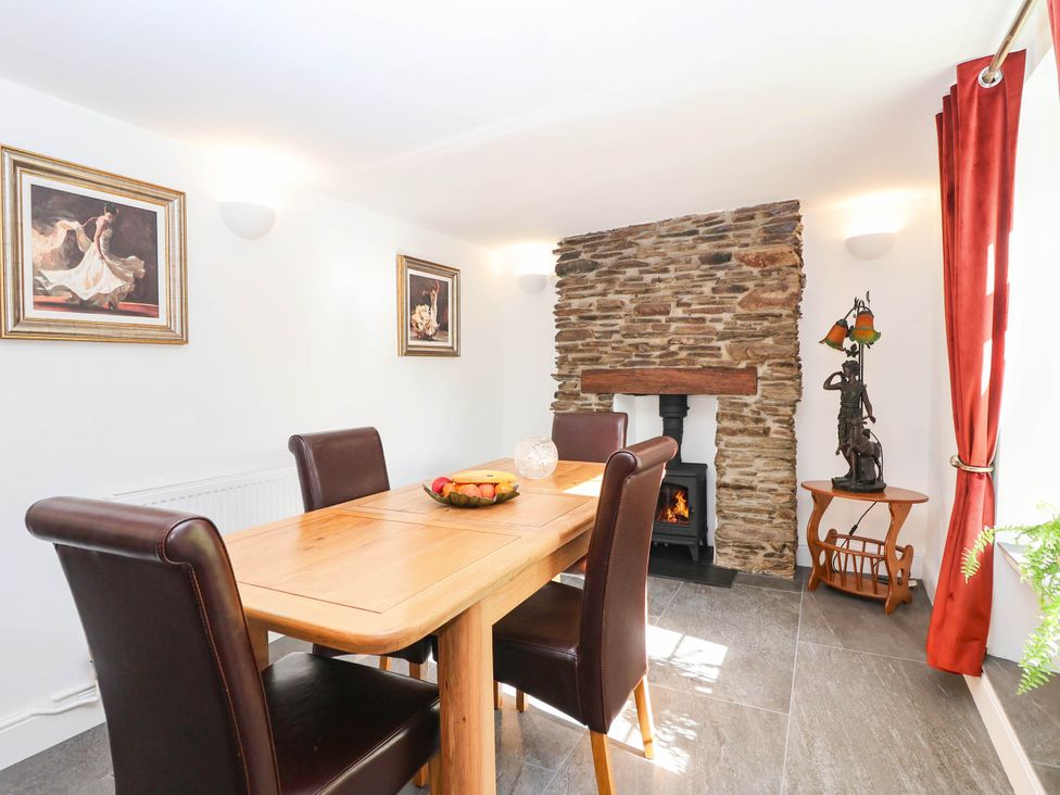 A dining room with a table and chairs in Swallow Cottage Sheviock near Crafthole