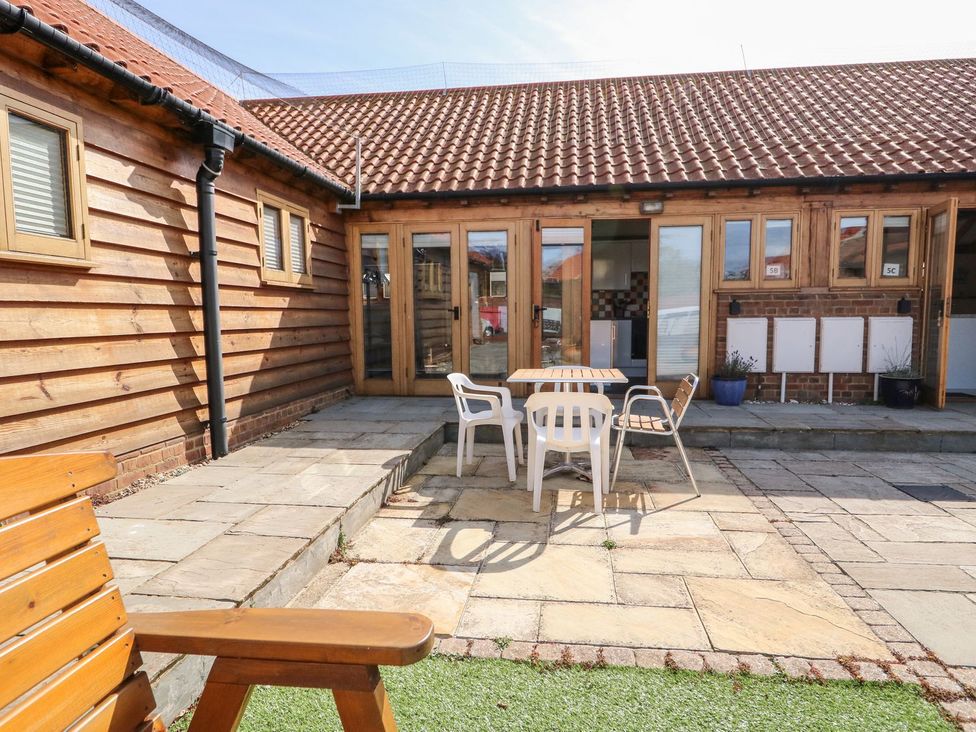 An outdoor area with a table and chairs at 5b Hideaways in Hunstanton