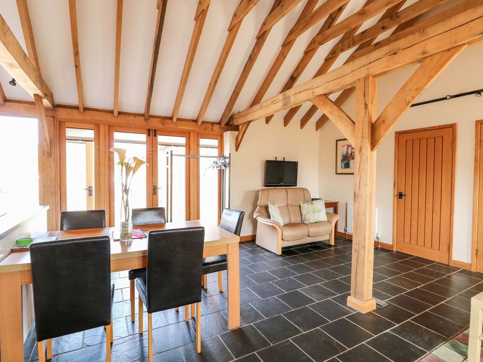 A living room with a dining table and chairs at 5b Hideaways in Hunstanton