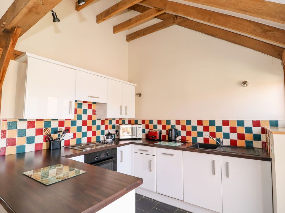 A kitchen with colorful tiles and appliances at 5b Hideaways in Hunstanton