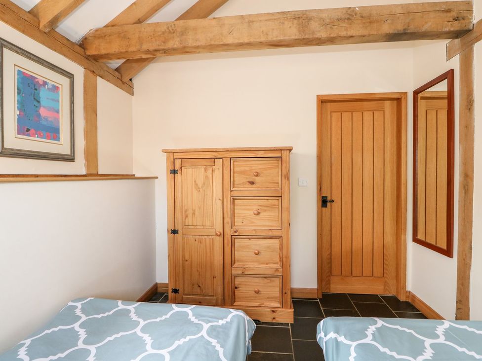 A bedroom with a wardrobe and a door at 5b Hideaways in Hunstanton