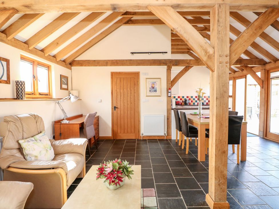 A living room with a sofa and dining table at 5b Hideaways in Hunstanton