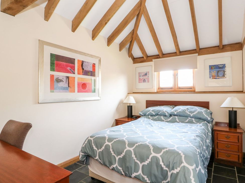 A bedroom with a bed and artwork at 5b Hideaways in Hunstanton