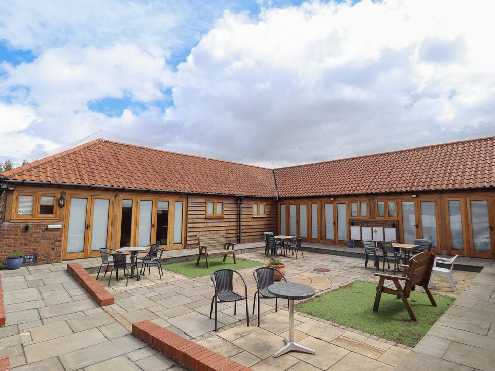 An outdoor area with tables and chairs at 3b Hideaways in Hunstanton