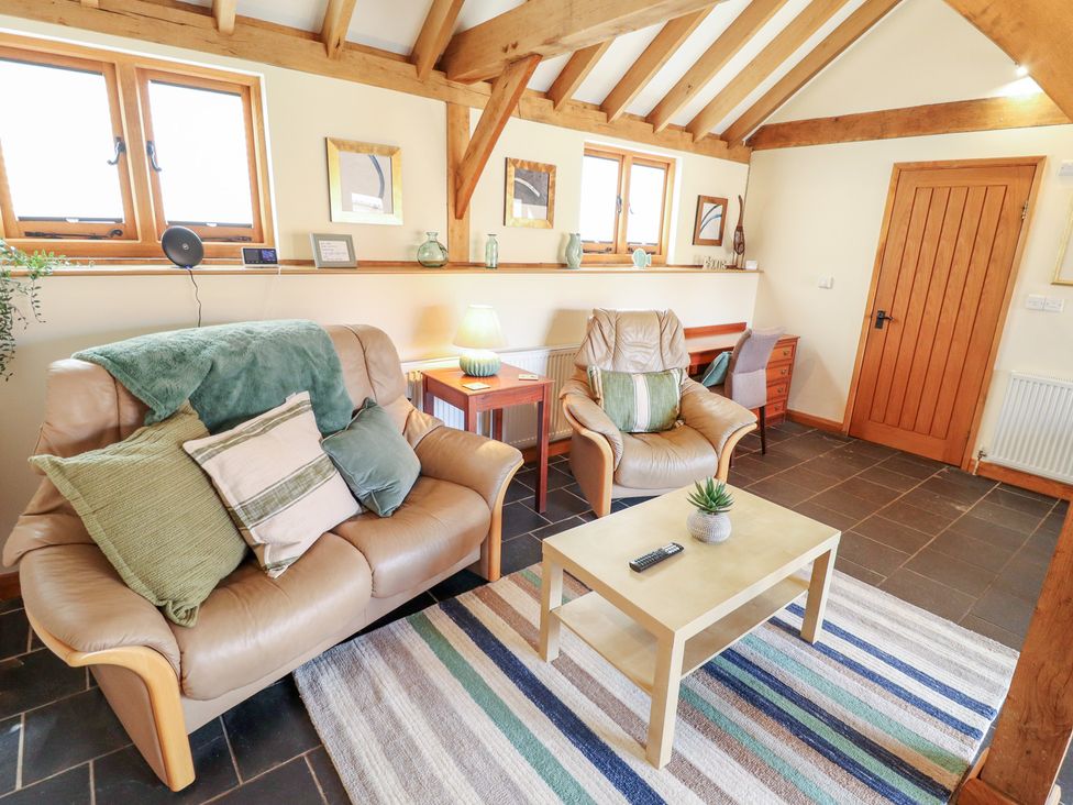 A living room with a sofa and chairs at 3b Hideaways in Hunstanton