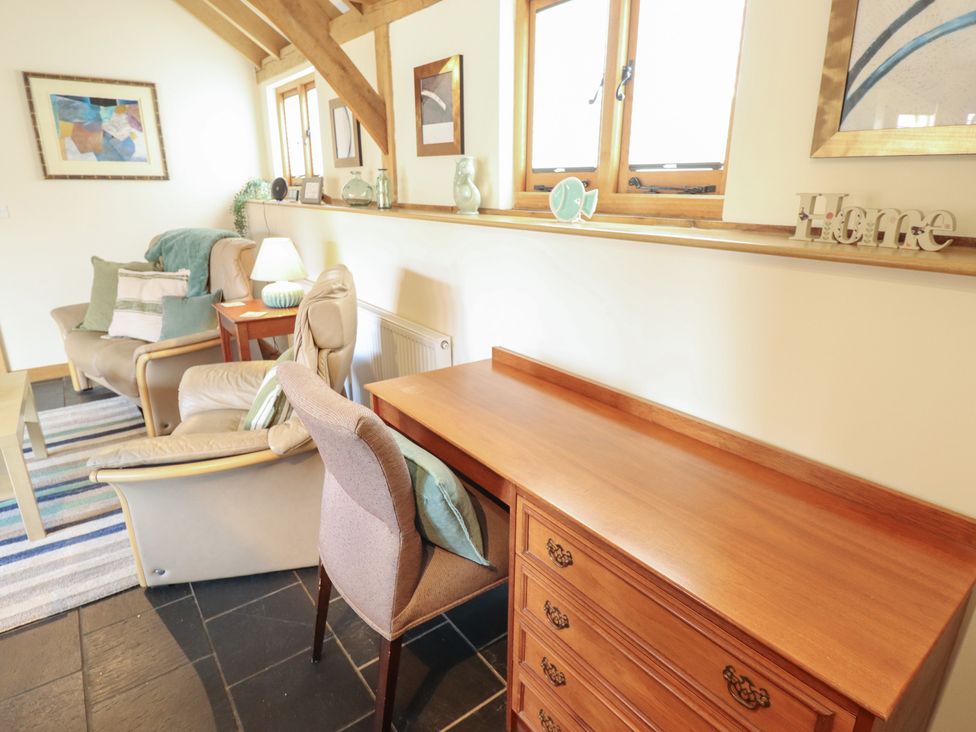 A living room with a sofa and desk at 3b Hideaways in Hunstanton