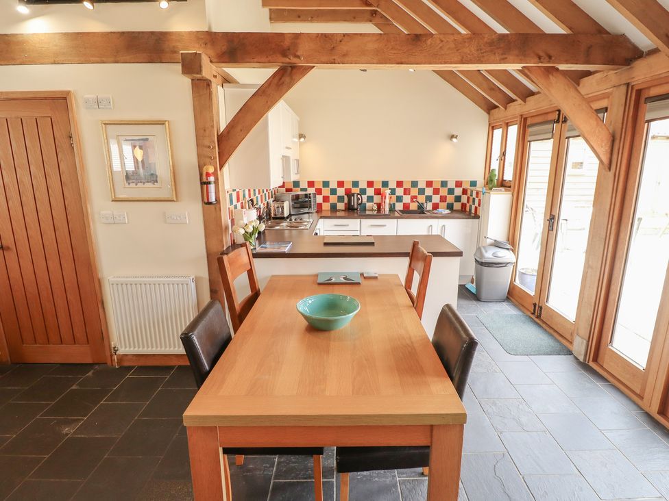 A kitchen with a dining table and chairs at 3b Hideaways in Hunstanton