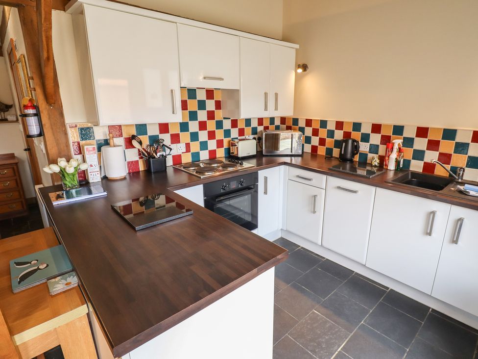 A kitchen with oven and microwave at 3b Hideaways in Hunstanton
