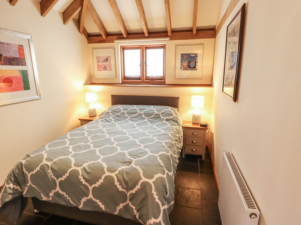 A bedroom with a bed and framed art at 3b Hideaways in Hunstanton