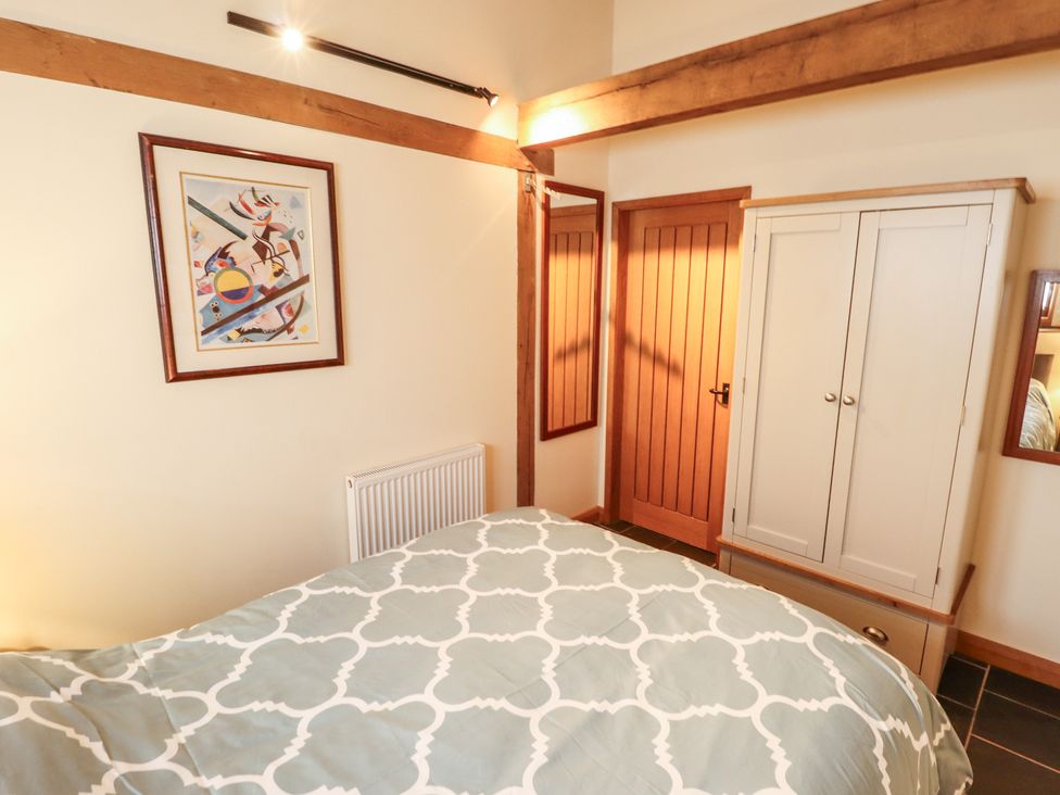 A bedroom with a bed and wardrobe at 3b Hideaways in Hunstanton
