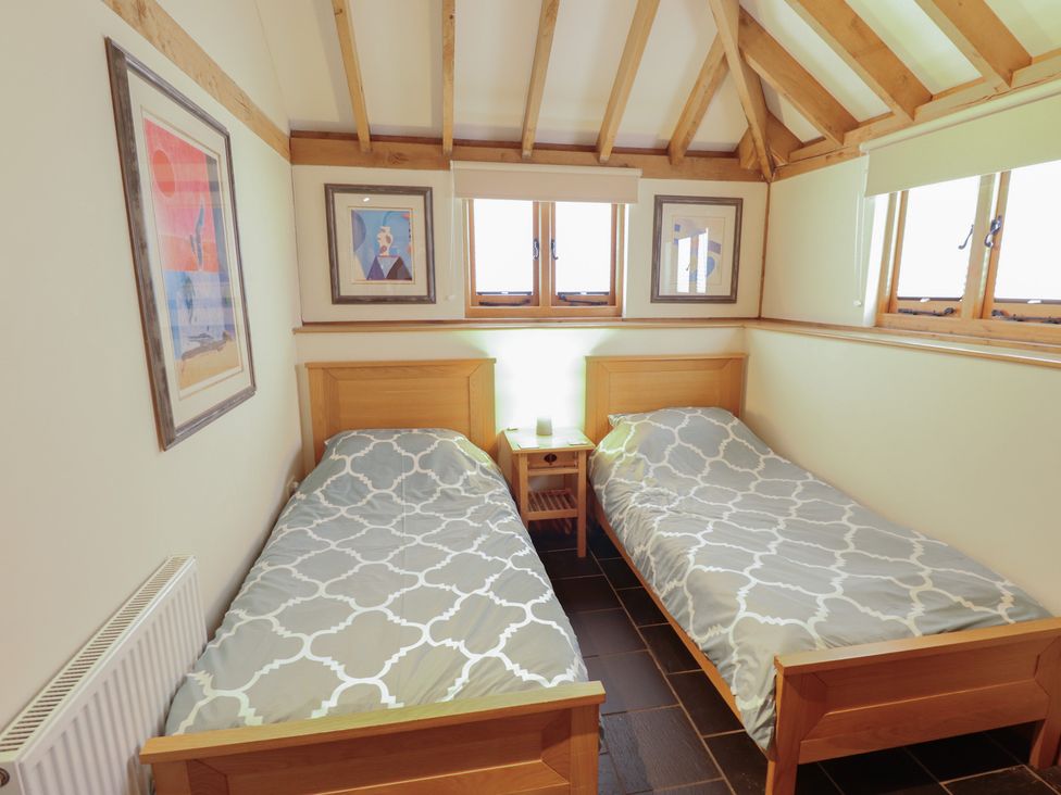 A bedroom with two single beds and a nightstand at 3b Hideaways in Hunstanton
