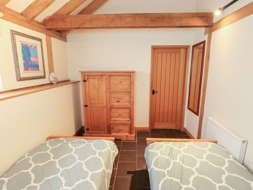 A bedroom with two beds and a chest of drawers at 3b Hideaways in Hunstanton
