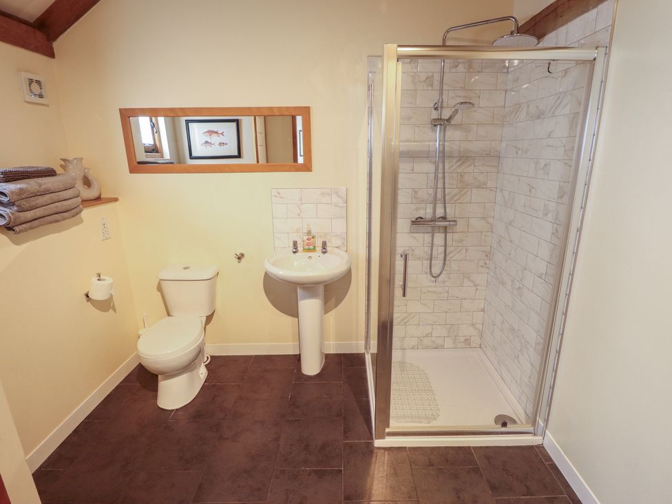 A bathroom with a shower and sink at 3b Hideaways in Hunstanton