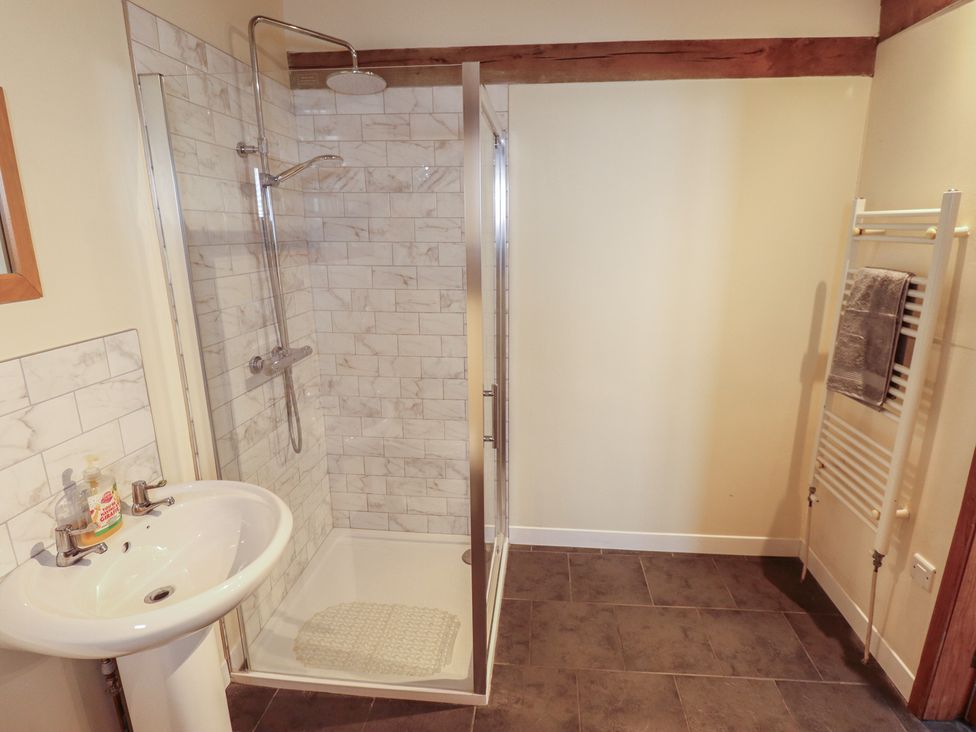 A bathroom with a shower and wash basin at 3b Hideaways in Hunstanton