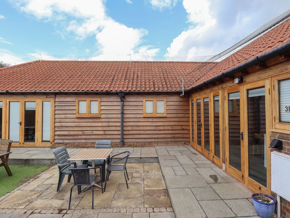 An outdoor area with a table and chairs at 3b Hideaways in Hunstanton