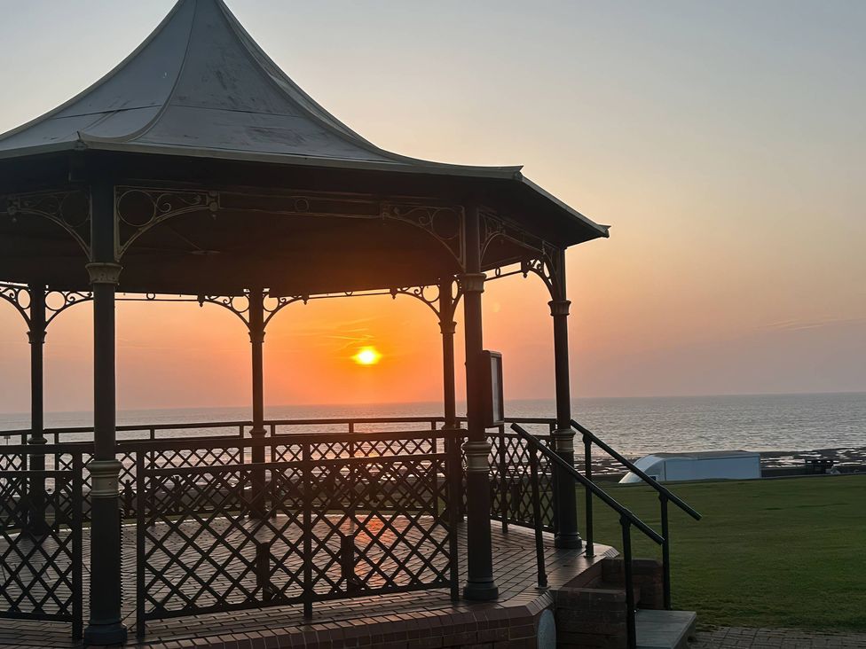 A pavilion with a view of the sunset over the sea at 3b Hideaways Hunstanton