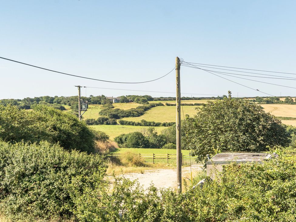 A rural landscape with fields and a power pole at Buttercup Cottage in St Merryn