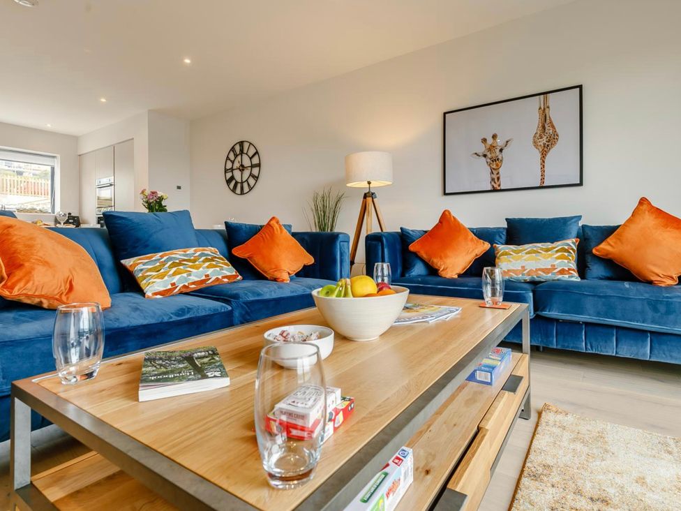 A living room with a coffee table and sofas at Seascape in Newquay