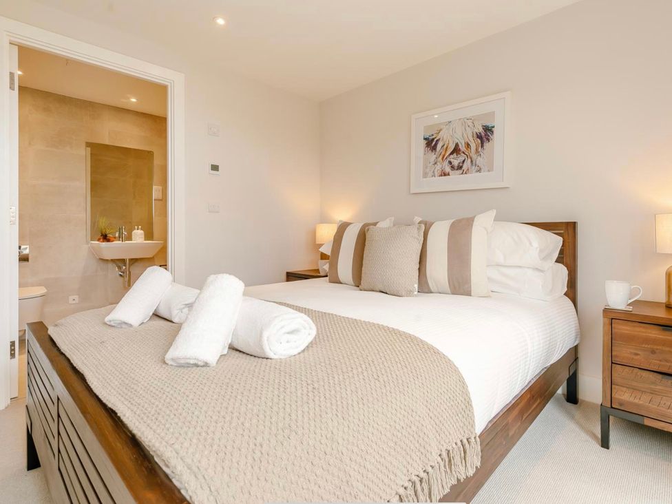 A bedroom with a bed and an ensuite at Seascape in Newquay