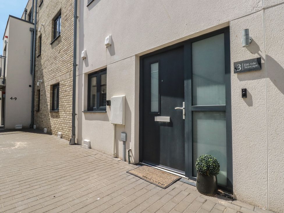 An entrance with a door and welcome mat at Ebb Tide Seascape in Newquay