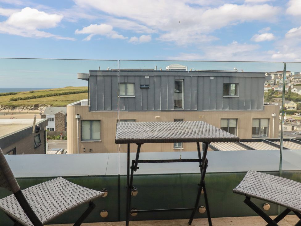 A table and chairs on a balcony with a view at Seascape in Newquay