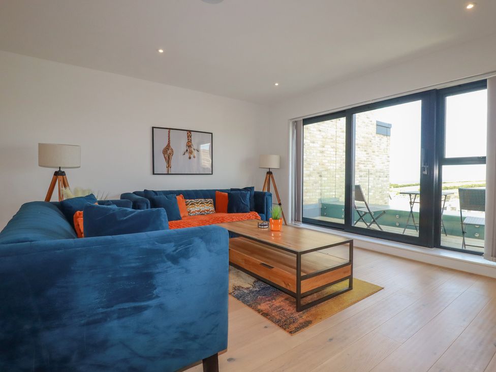 A living room with a sofa and coffee table at Seascape in Newquay