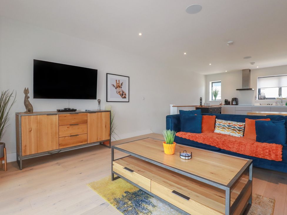 A living room with a television and couch at Seascape in Newquay