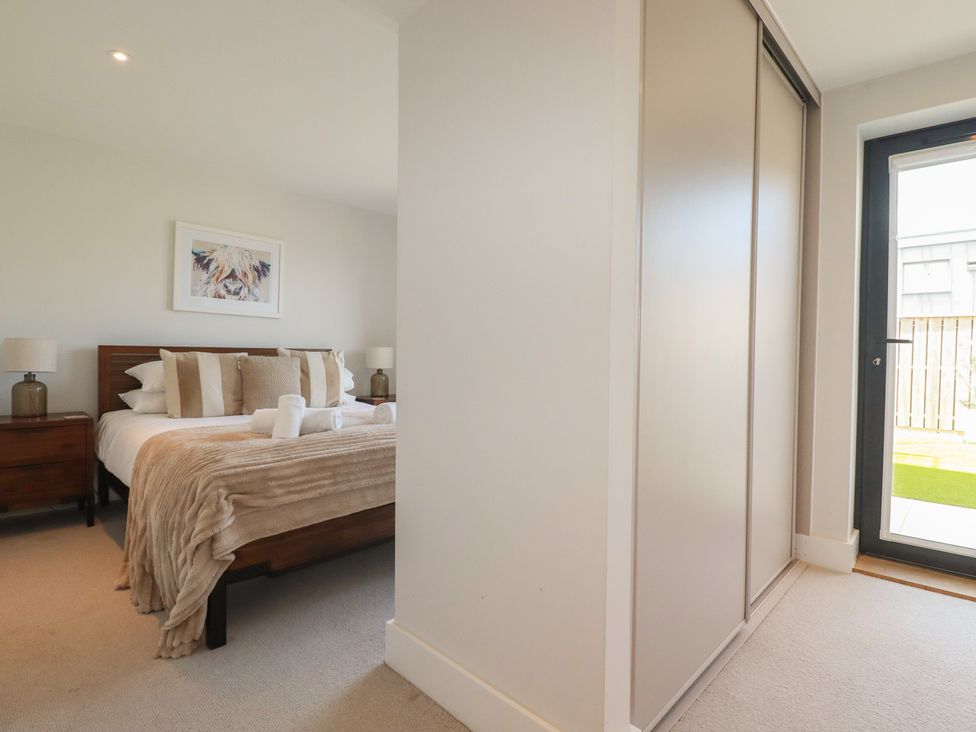 A bedroom with a bed and nightstand at Seascape in Newquay
