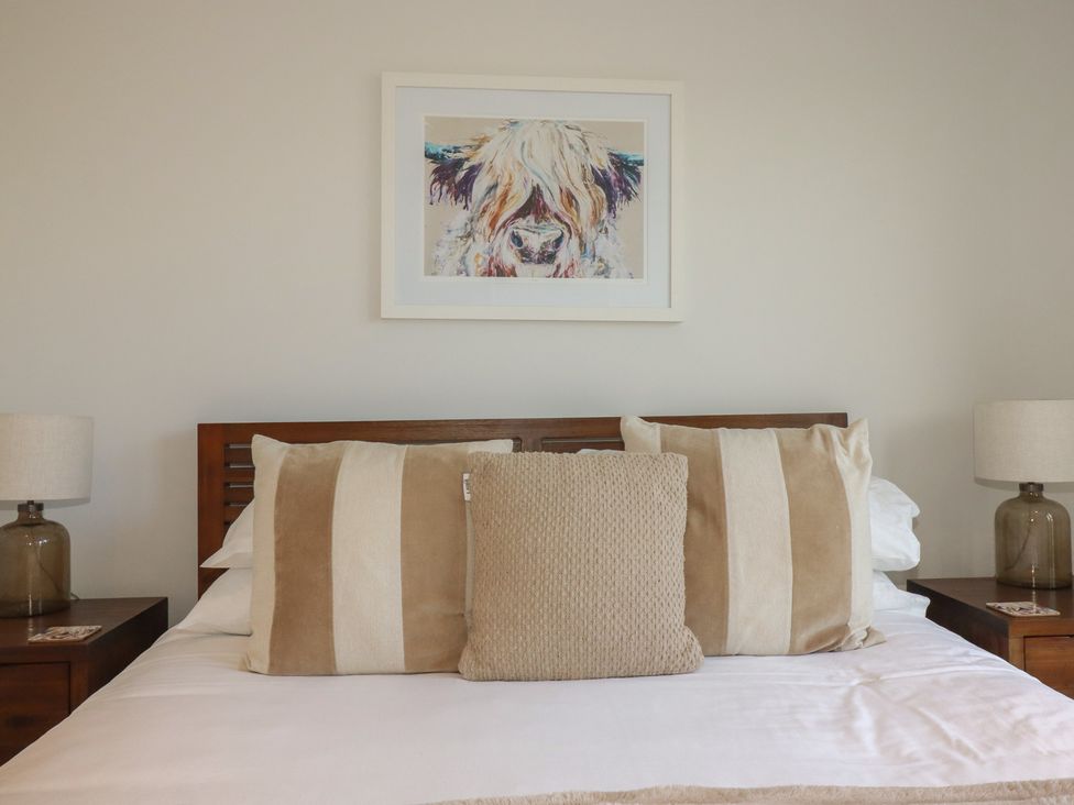A bedroom with a bed and bedside tables at Seascape in Newquay