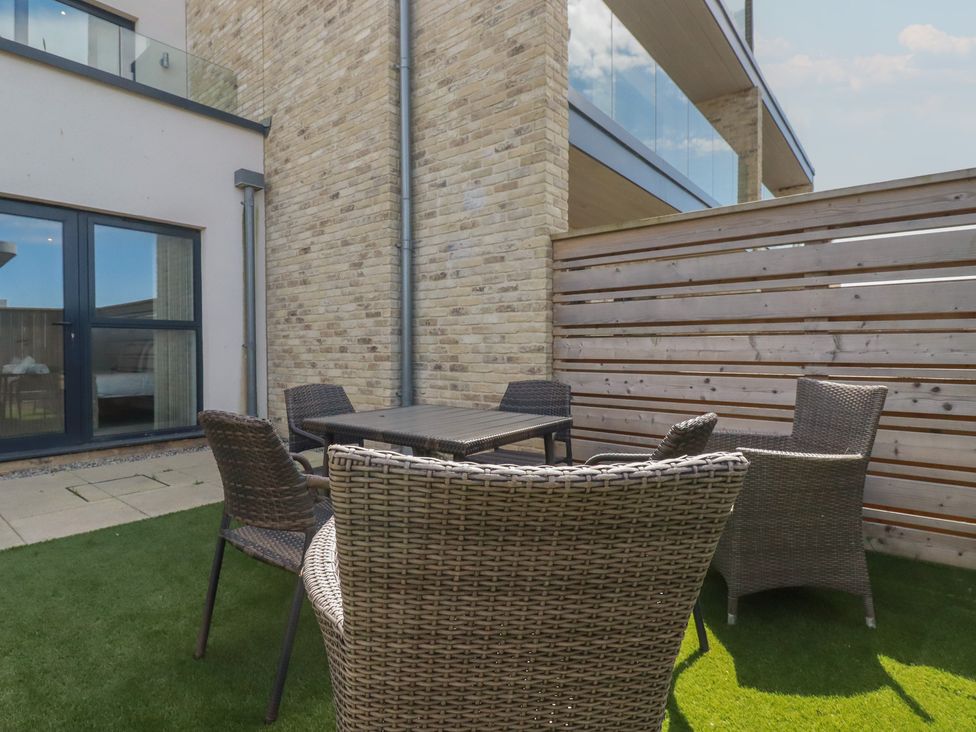 An outdoor seating area with a table and chairs at Seascape in Newquay