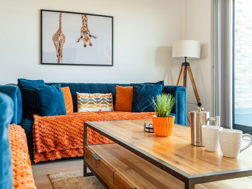 A living room with a coffee table and a sofa at Seascape in Newquay