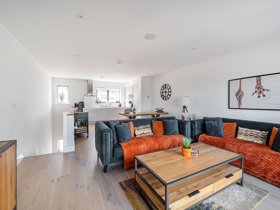 A living room with a coffee table and sofa at Seascape in Newquay
