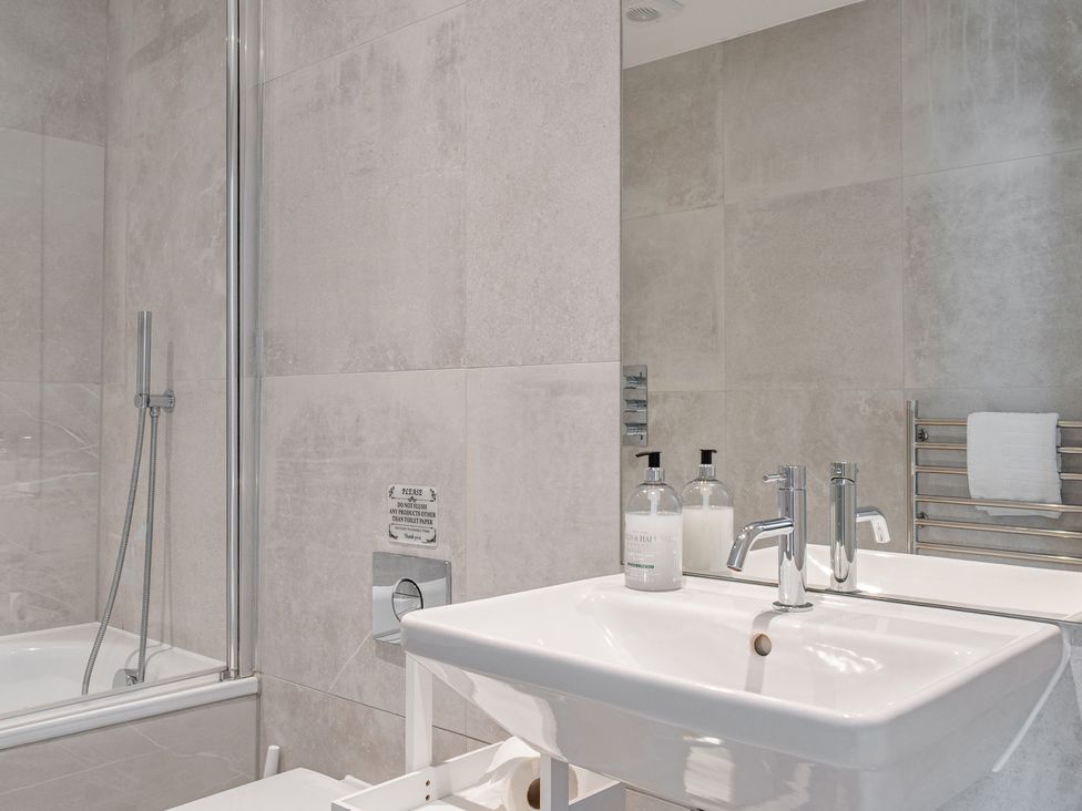 A bathroom with shower and sink at Seascape in Newquay