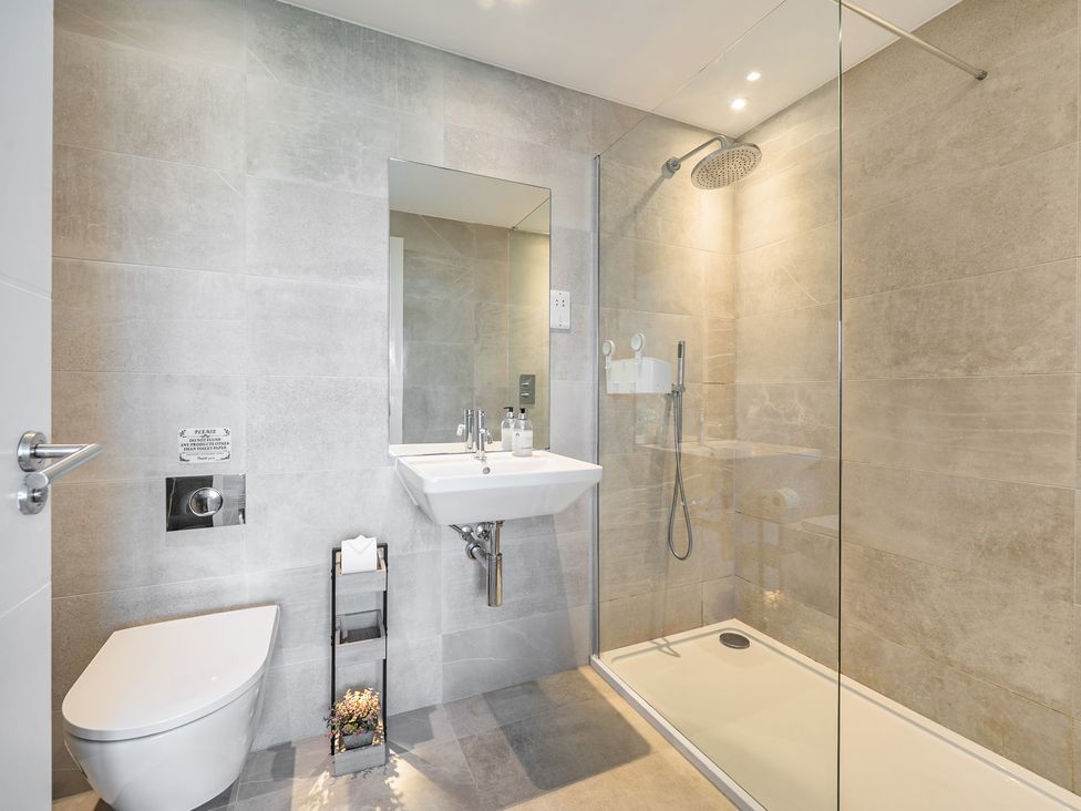 A bathroom with a shower and sink at Seascape in Newquay