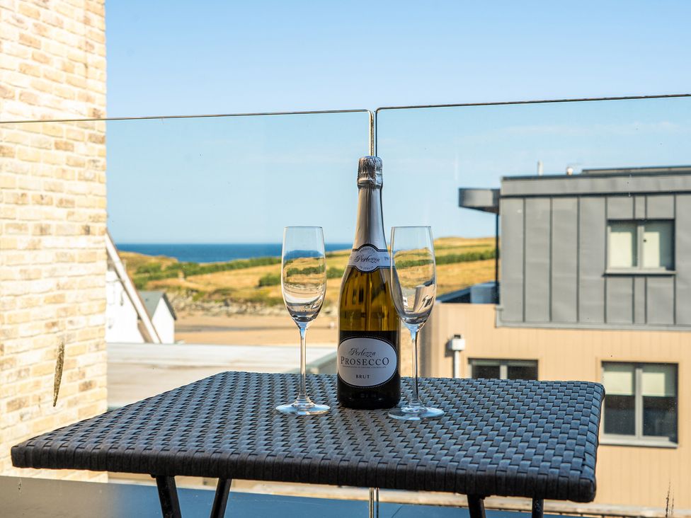 An outdoor table with a bottle of Prosecco and glasses at Seascape in Newquay