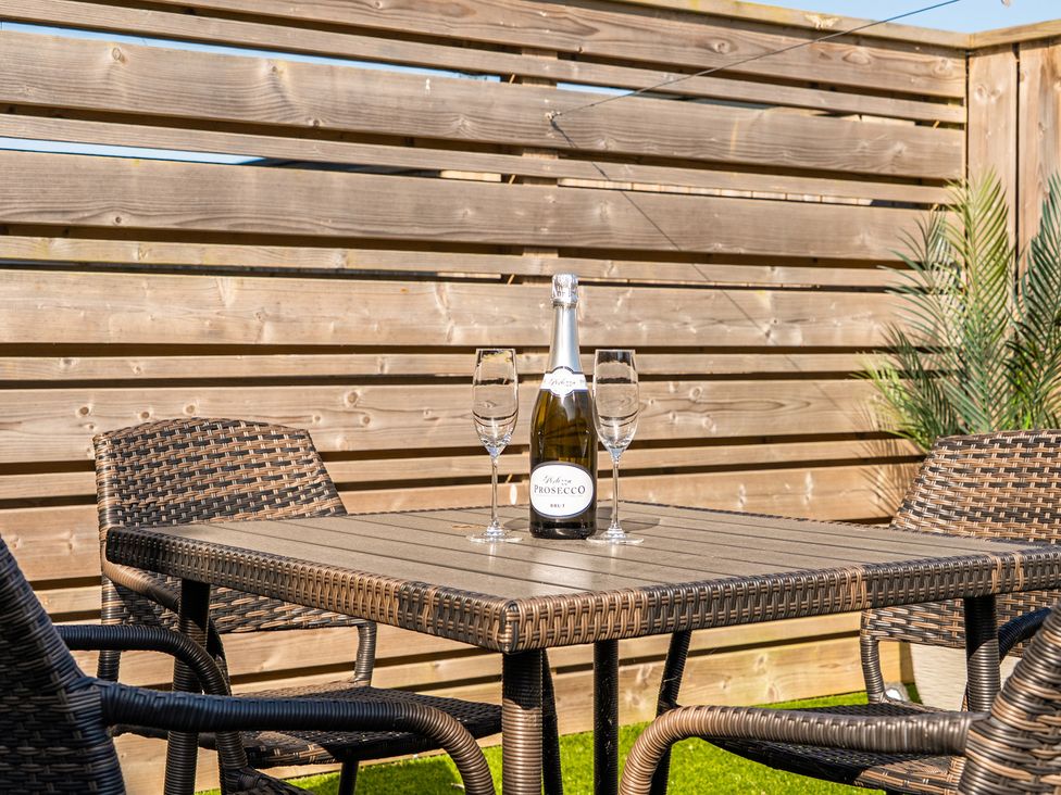 An outdoor area with a table set for drinks at Seascape in Newquay