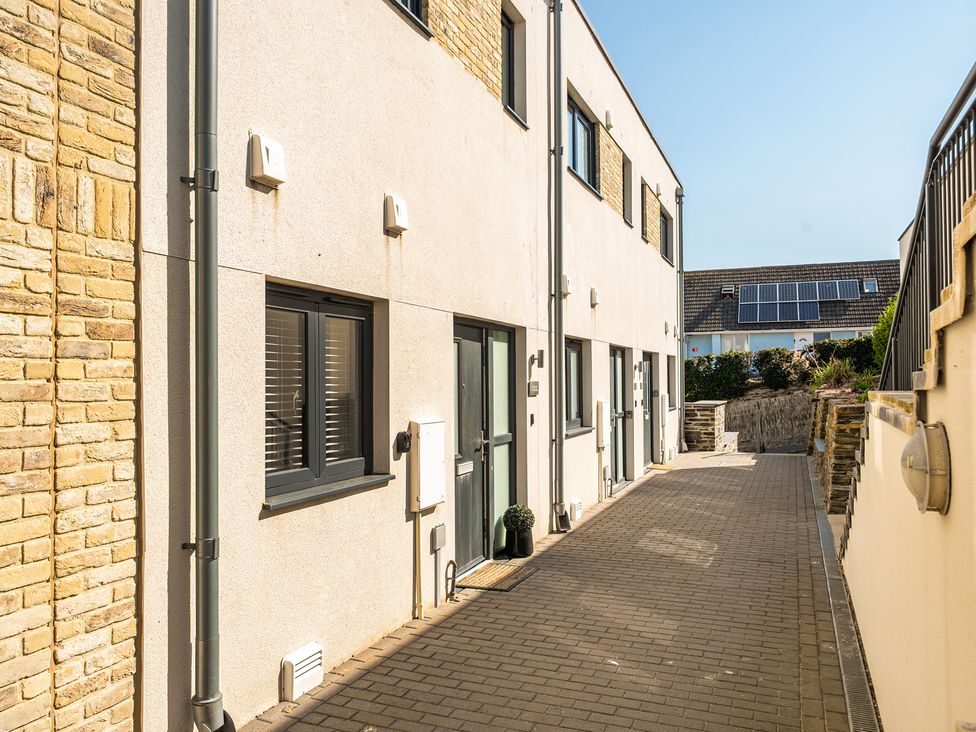 An outdoor area with a pathway and several units at Seascape in Newquay