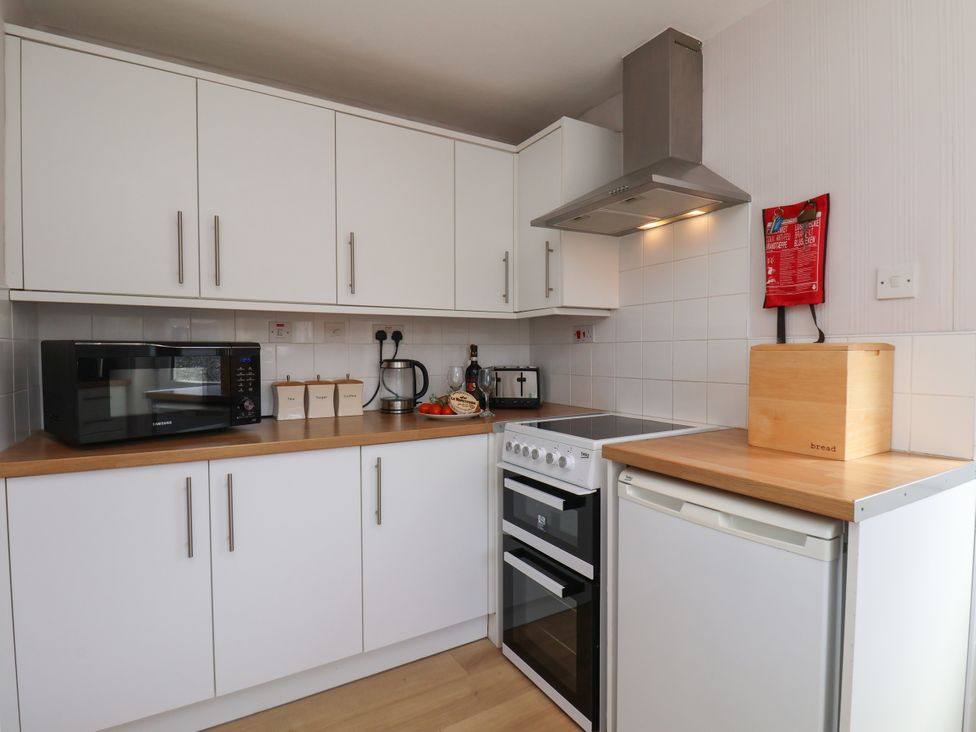 A kitchen with appliances and storage at Wheeldale Cottage Goathland
