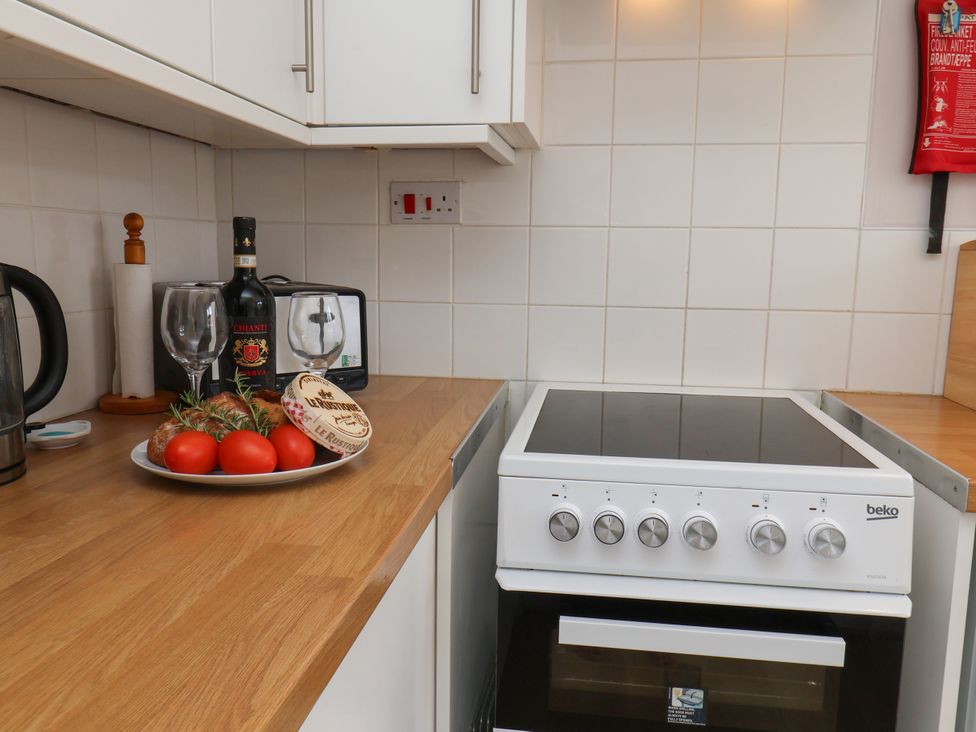 A kitchen with a stove and kitchenware at Wheeldale Cottage in Goathland