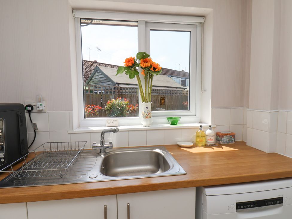 A kitchen with a sink and window at Wheeldale Cottage in Goathland