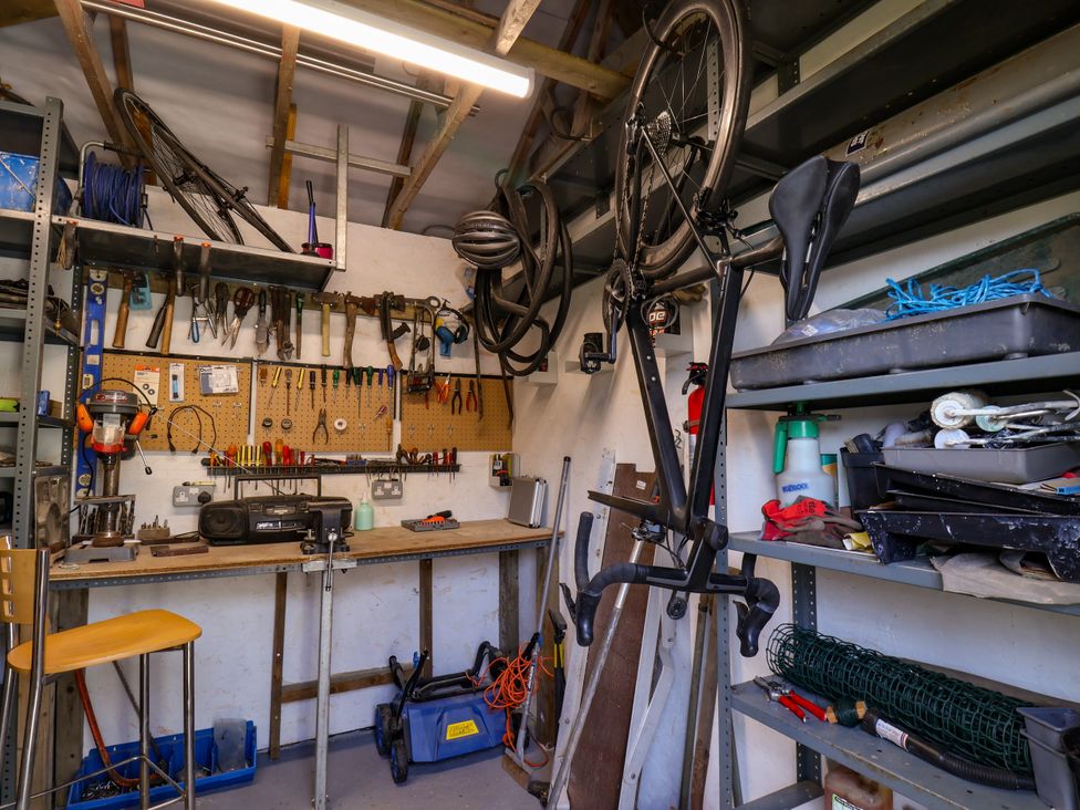 A garage with tools and a bike hanging on the wall at Wheeldale Cottage in Goathland