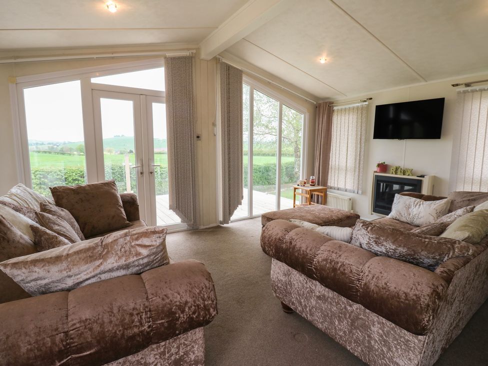 A living room with sofas and a television at Plot 34 Carlisle