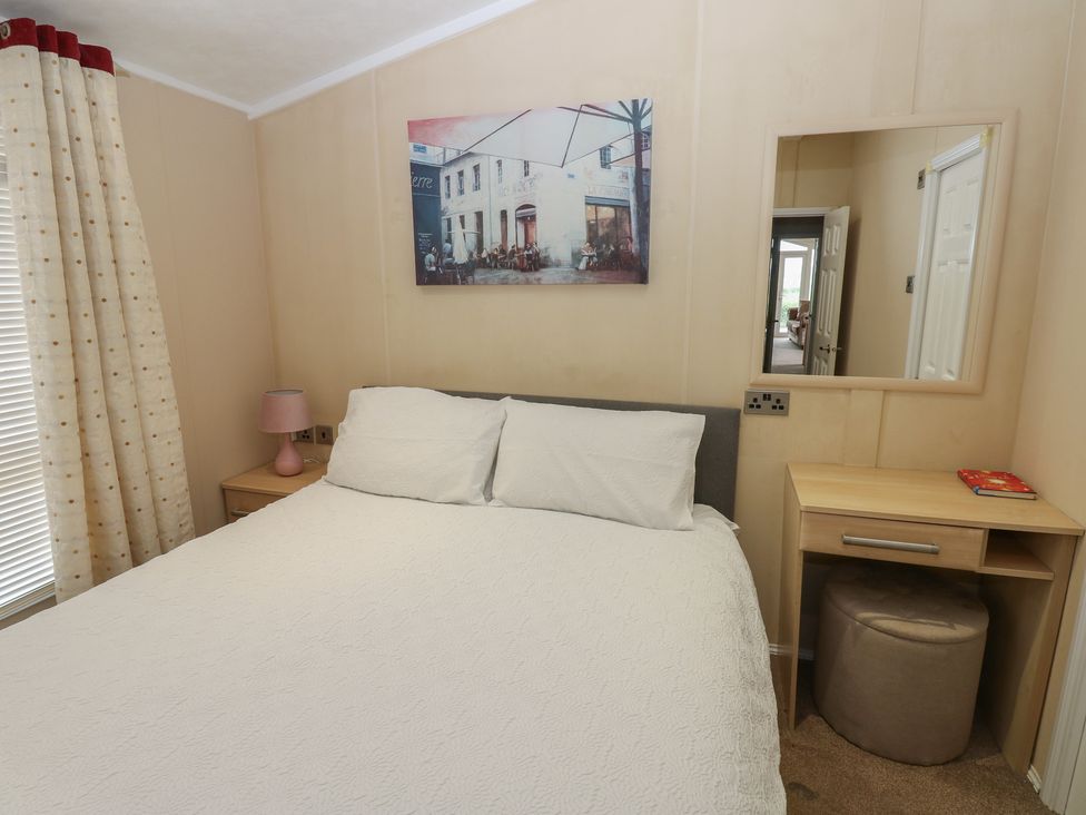A bedroom with a double bed and bedside table at Plot 34 Carlisle