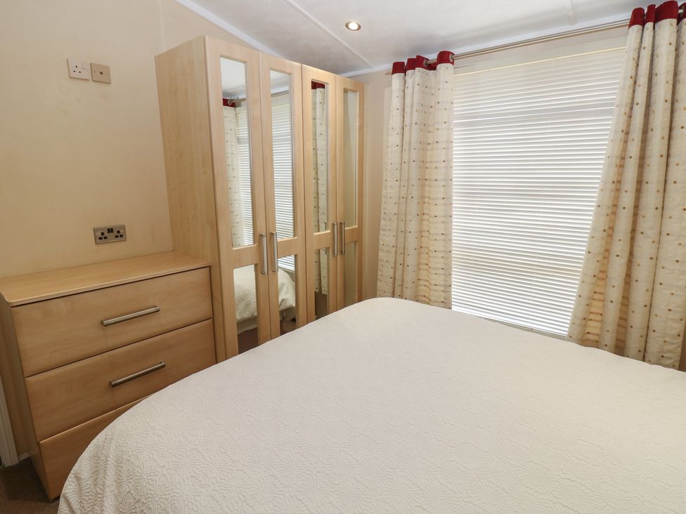 A bedroom with a bed and wardrobe at Plot 34 Carlisle