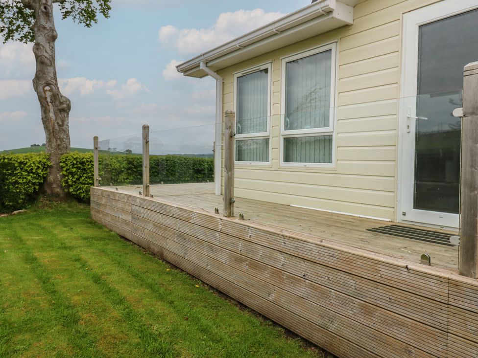 A deck area with a door and windows at Plot 34 Carlisle