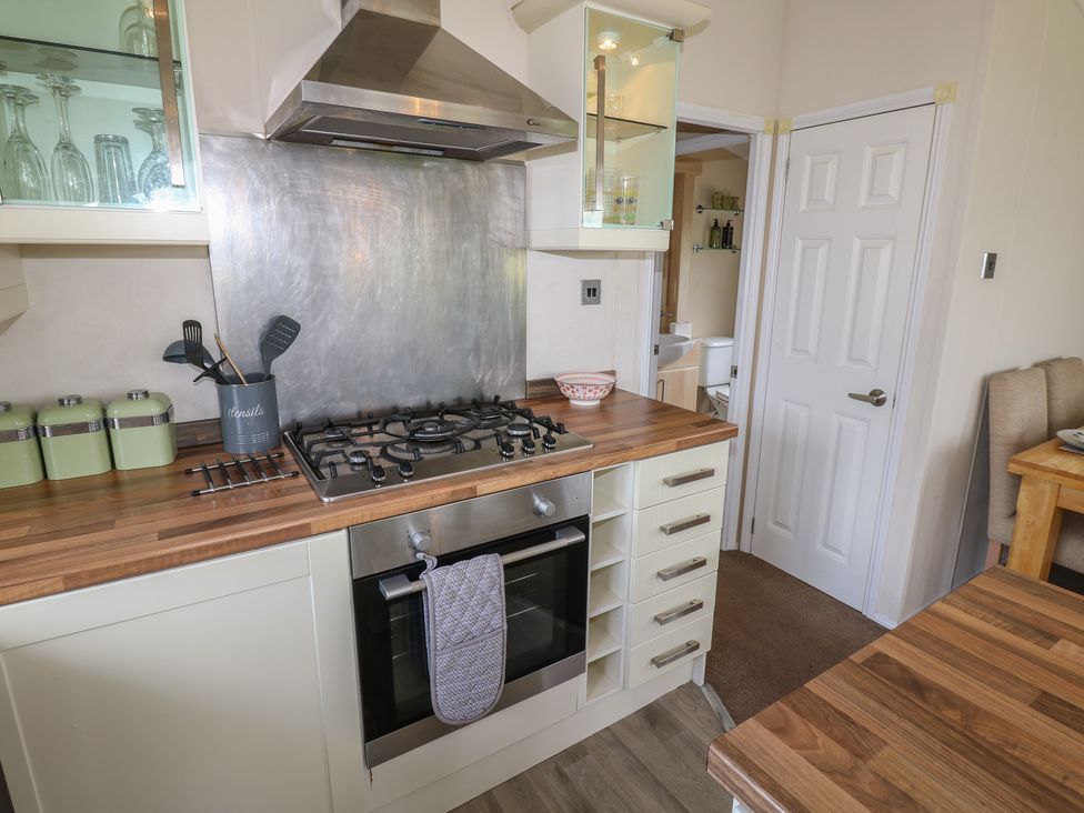 A kitchen with a gas stove and wooden countertops at Plot 34 near Armathwaite
