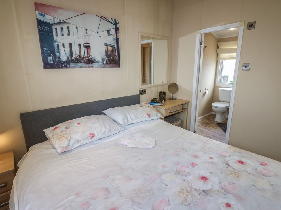 A bedroom with a bed and an attached bathroom at Plot 34 near Armathwaite
