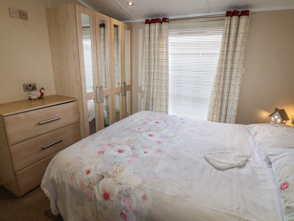 A bedroom with a bed and wardrobe at Plot 34 near Armathwaite