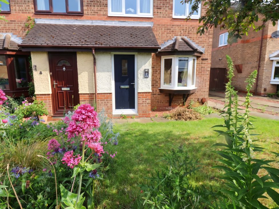 A garden with flowers in front of a house at 7 Crestbrooke in Northallerton